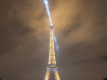 Eiffel Tower illuminated at night with its lighthouse