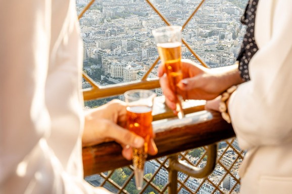 Drinking champagne at the top of the Eiffel Tower